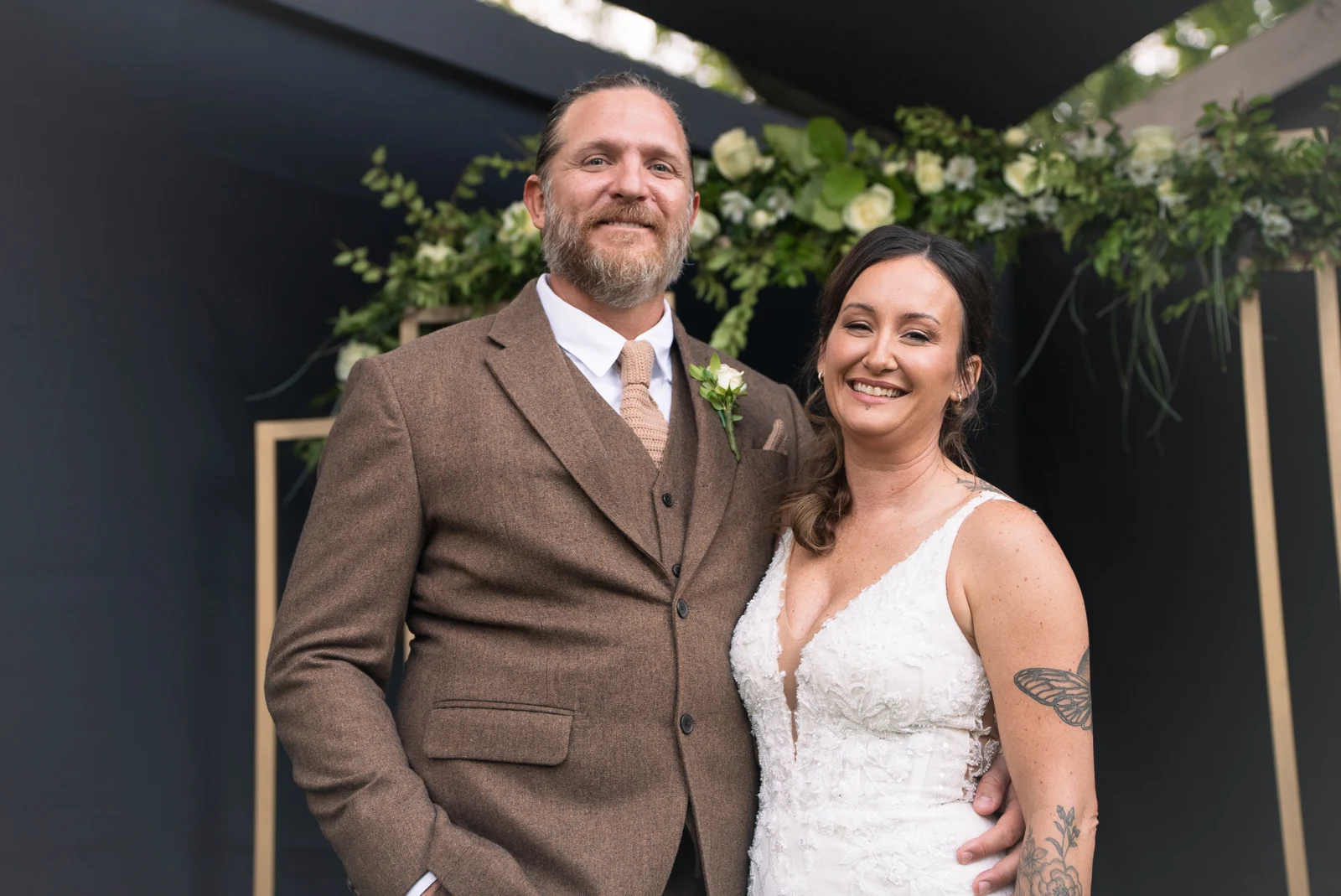 Darin and Kelly standing together beneath the trees