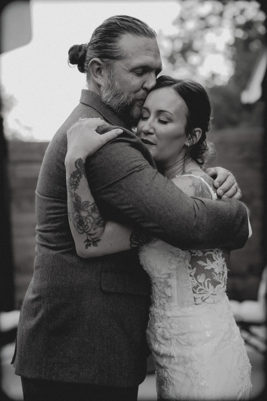 Darin and Kelly sharing a quiet embrace, photographed in black and white